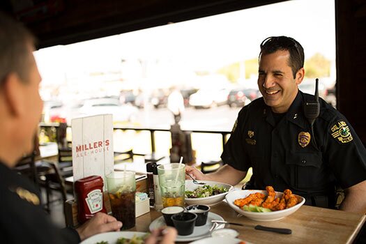 a police officer enjoying chicken zingers at miller's ale house